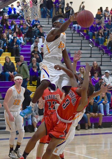 Lemoore's Daniel Charleston goes high to prevent Hanford's Jupri Hughes from scoring.